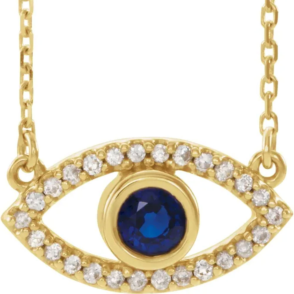 Elegant 14k Gold Evil Eye Pendant featuring a deep blue sapphire center and diamond embellishments, displayed on a white background.