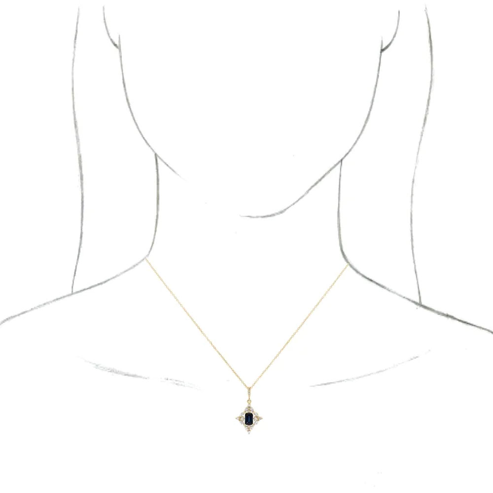 A model wears this 14k yellow gold Necklace with blue sapphire and diamonds, showing the necklace's length and fit.