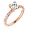 The brilliance of a 0.70 carat round diamond shines in this meticulously crafted engagement ring.