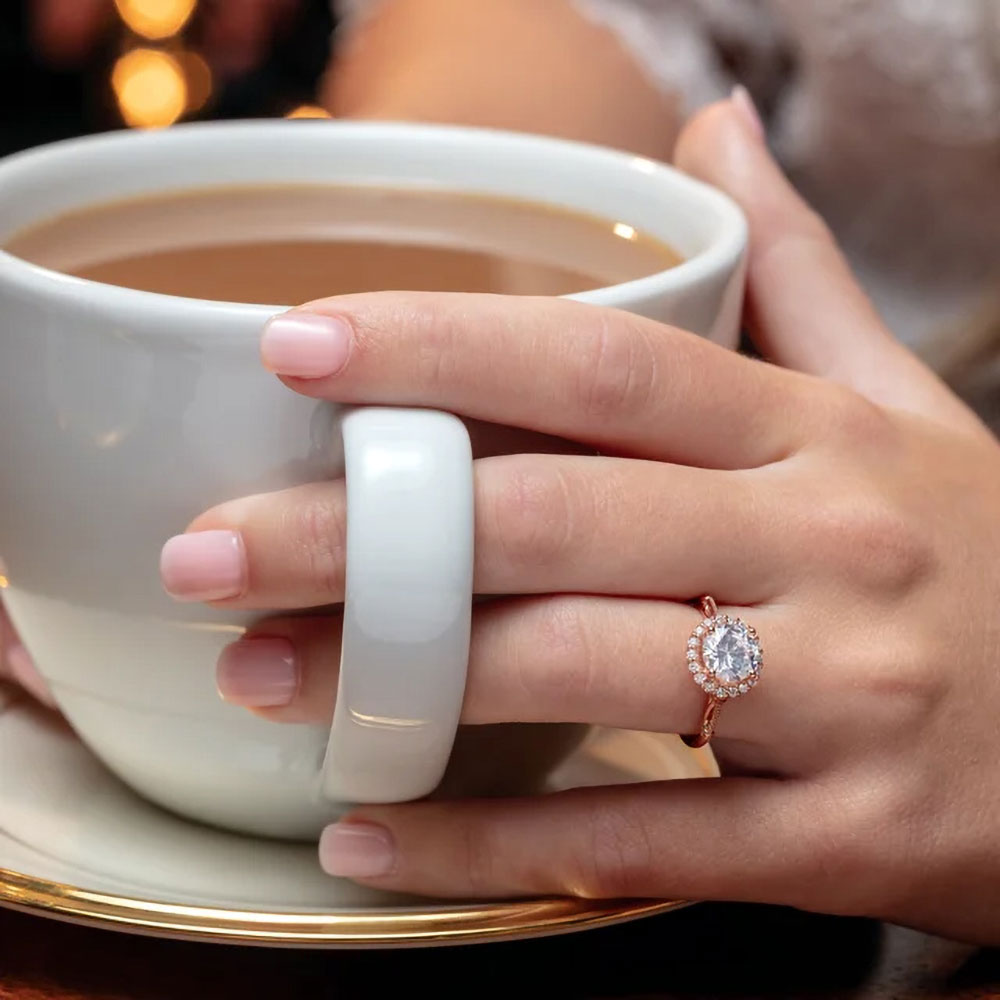 This halo engagement ring features a 1.5 carat lab-created diamond, a testament to sustainable love.