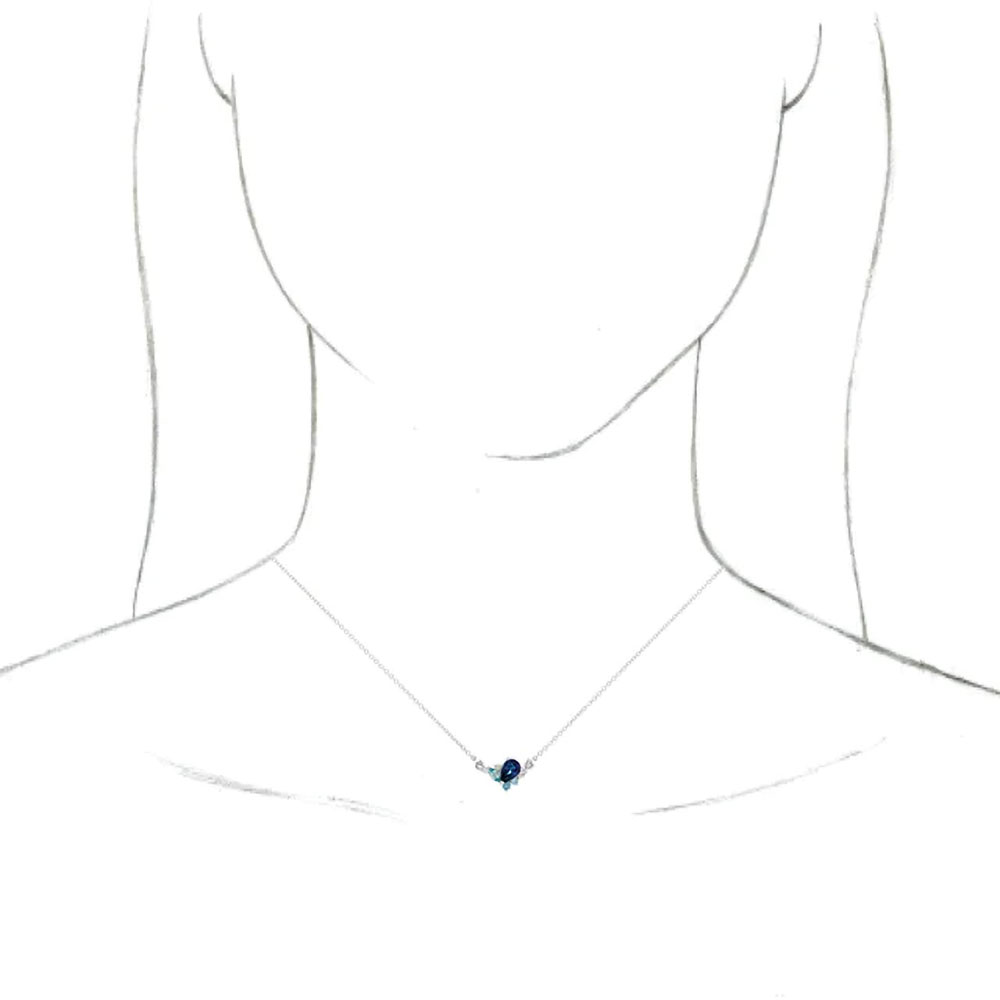 14k gold necklace with sapphire, aquamarine, diamond, and zircon, displayed on a model, highlighting the jewelry's fit and fall.