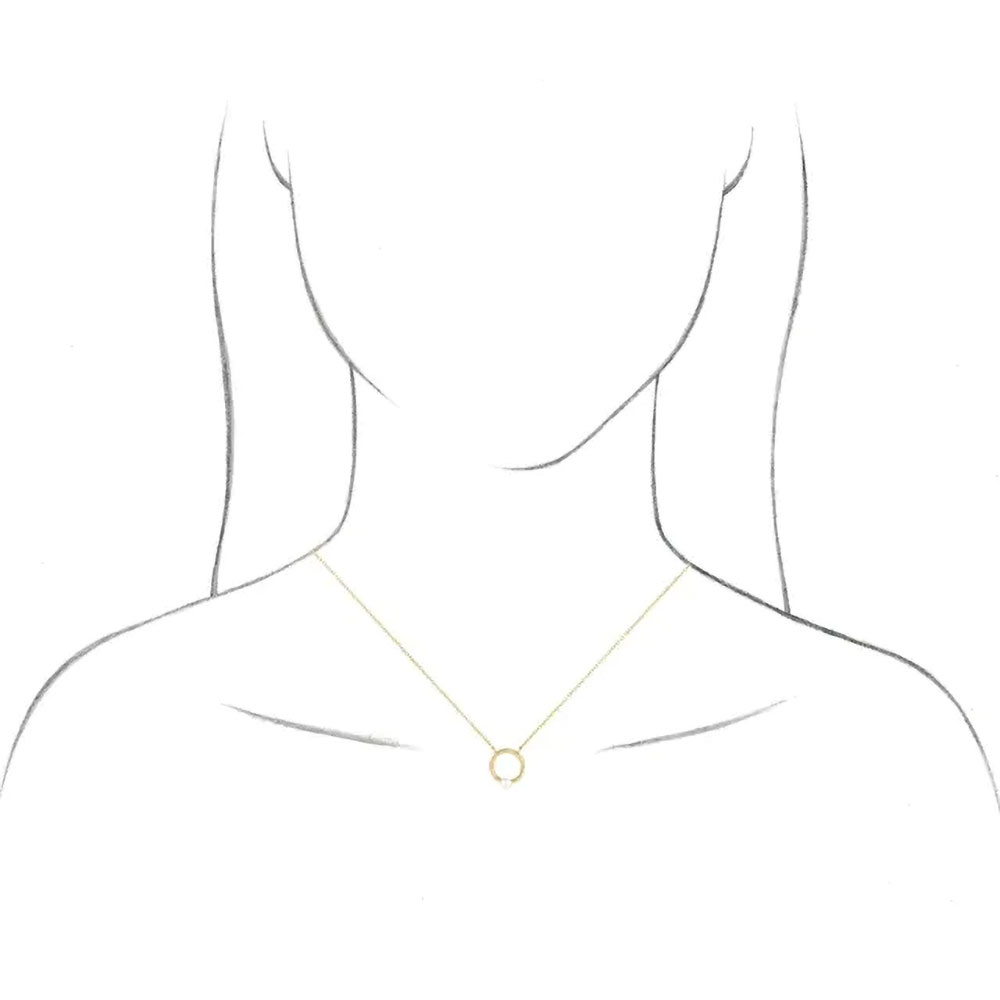 A model displays our 14k gold pearl circle necklace, demonstrating its elegant drape and fit on the neckline.