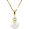 A product image of a pearl necklace with diamonds in 14k yellow gold.