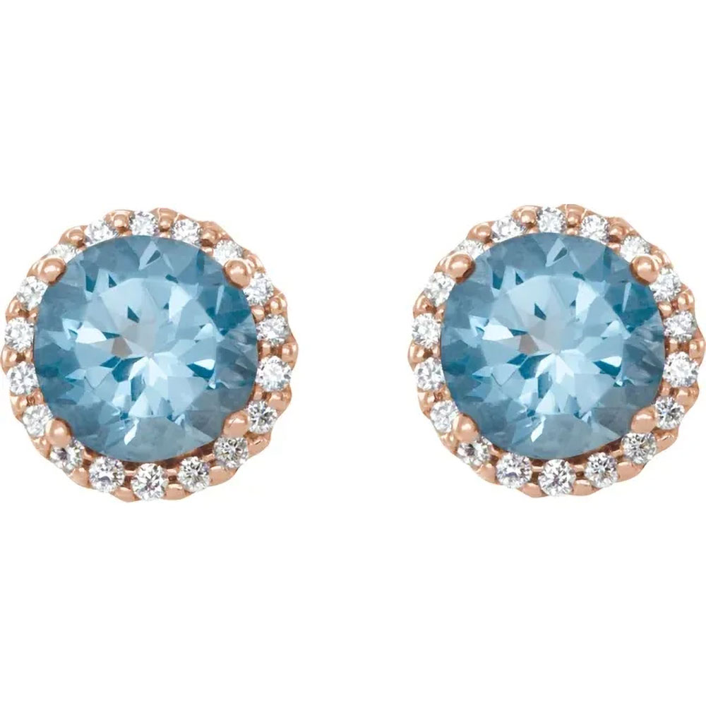 Soothing aquamarine stones ringed with diamonds in 14K gold studs offer a peaceful, elegant statement.