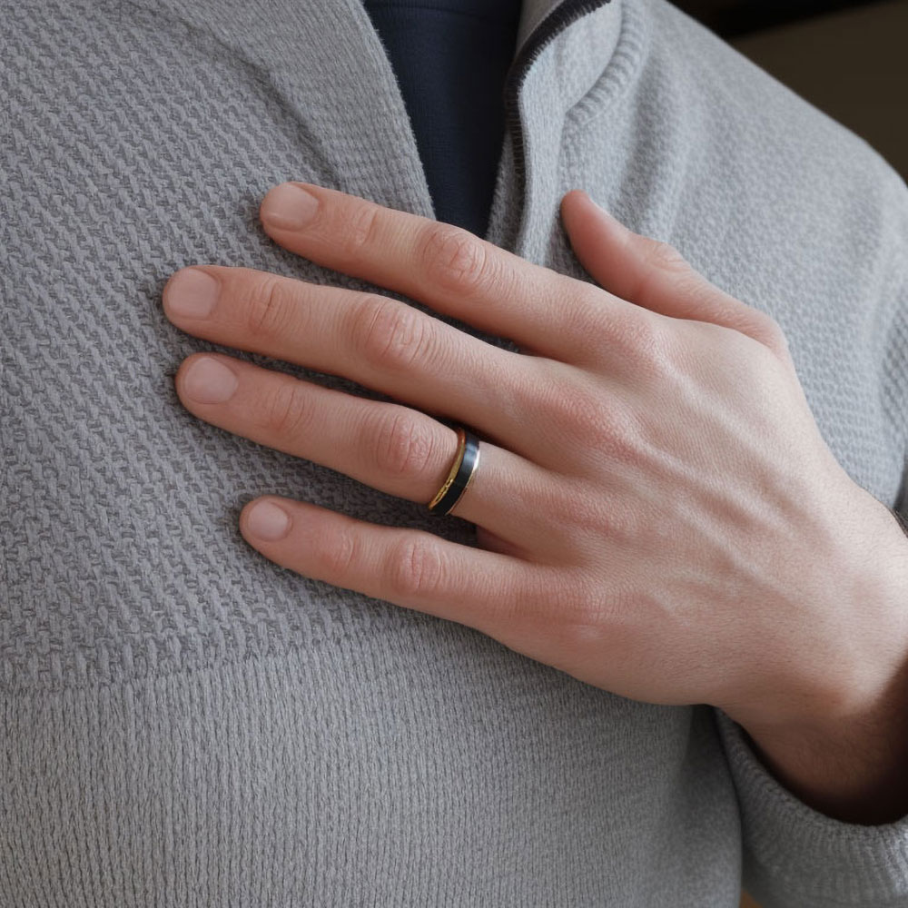 Hand model wearing our black tungsten ring with gold accent, symbolizing a blend of modern style and enduring commitment.