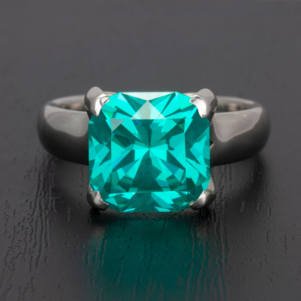 Symbolizing eternal love, this 14k white gold garnet engagement ring features the highly sought after Paraiba blue-green colour.