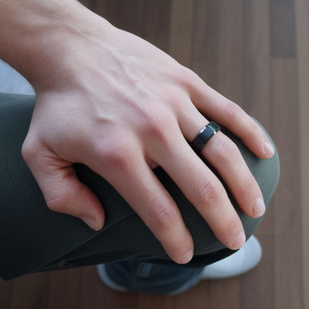 Image capturing a man's hand adorned with our black tungsten ring, where the beveled edges catch the light, symbolizing enduring strength and style.