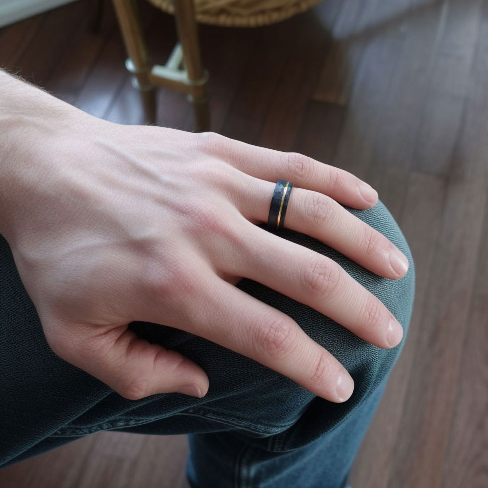 Hand model displaying our black tungsten & 18k gold wedding band, exemplifying the ring's durable appeal for everyday wear.